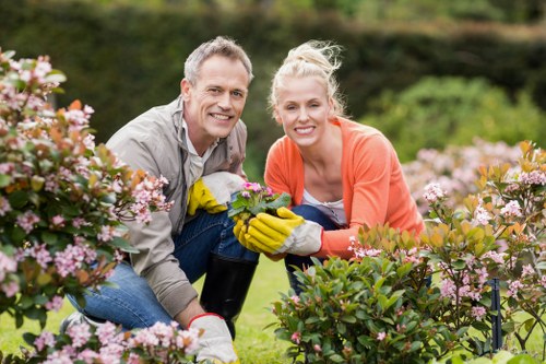 Happy clients with beautifully trimmed hedges